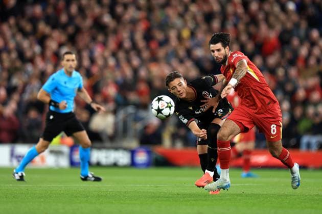 Liverpool, England, 2nd October 2024. Dominik Szoboszlai of Liverpool is challenged by Kacper Urbanski of Bologna during the UEFA Champions League match at Anfield, Liverpool. Picture credit should read: Jessica Hornby Sportimage EDITORIAL USE ONLY. No use with unauthorised audio, video, data, fixture lists, club league logos or live services. Online in-match use limited to 120 images, no video emulation. No use in betting, games or single club league player publications. SPI-3353-0071