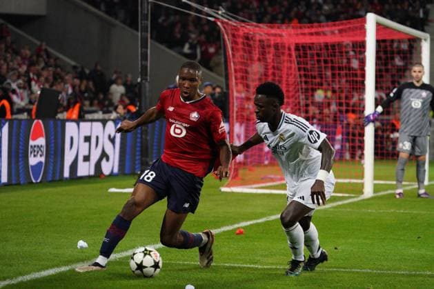 Bafode Diakite of Lille holds off Vinicius Junior of Real Madrid Lille v Real Madrid, UEFA Champions League, Group Stage, Football, Pierre Mauroy Stadium, Lille, France, 02 Oct 2024 EDITORIAL USE ONLY No use with unauthorised audio, video, data, fixture lists, club league logos or live services. Online in-match use limited to 120 images, no video emulation. No use in betting, games or single club league player publications. Copyright: xDavexWinter Shutterstockx 14750773ke