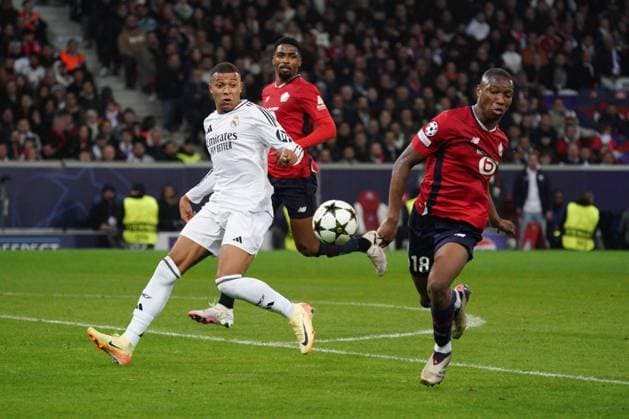 Vinicius Junior of Real Madrid and Bafode Diakite of Lille Lille v Real Madrid, UEFA Champions League, Group Stage, Football, Pierre Mauroy Stadium, Lille, France, 02 Oct 2024 EDITORIAL USE ONLY No use with unauthorised audio, video, data, fixture lists, club league logos or live services. Online in-match use limited to 120 images, no video emulation. No use in betting, games or single club league player publications. Copyright: xDavexWinter Shutterstockx 14750773ka