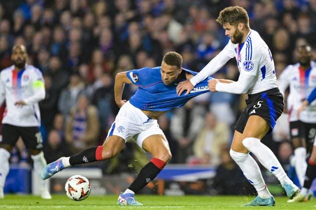 GLASGOW, SCOTLAND - OCTOBER 3: James Tavernier of Rangers FC (L) is challenged by Duje Caleta-Car of Olympique Lyon (R) during the UEFA Europa League 2024 25 League Phase Matchday 2 match between Rangers FC and Olympique Lyonnais at Ibrox Stadium on October 03, 2024 in Glasgow, Scotland. FOOTBALL : Glasgow Rangers Vs Olympique Lyonnais - Ligue Europa - 03 10 2024 RichardCallis Panoramic 