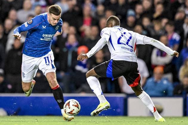 GLASGOW, SCOTLAND - OCTOBER 3: Tom Lawrence of Rangers and Clinton Mata of Lyon during the UEFA Europa League 2024 25 League Phase Matchday 2 match between Rangers FC and Olympique Lyonnais at Ibrox Stadium on October 03, 2024 in Glasgow, Scotland. FOOTBALL : Glasgow Rangers Vs Olympique Lyonnais - Ligue Europa - 03 10 2024 RichardCallis Panoramic 