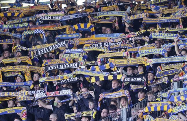 Fan scarves of the Braunschweig fans with ANTIHANOI football, men, season 2024 2025 2 BL, Eintracht stadium, Eintracht Braunschweig vs Hannover 96, Lower Saxony derby, 2 0 DFL REGULATIONS PROHIBIT ANY USE OF PHOTOGRAPHS AS IMAGE SEQUENCES AND OR QUASI VIDEO