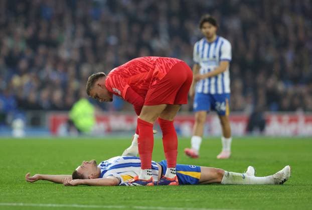 Brighton and Hove, England, 6th October 2024. Adam Webster of Brighton and Hove Albion is checked on by team mate Bart Verbruggen of Brighton and Hove Albion after picking up an injury and later being substituted during the Premier League match at the AMEX Stadium, Brighton and Hove. Picture credit should read: Paul Terry Sportimage EDITORIAL USE ONLY. No use with unauthorised audio, video, data, fixture lists, club league logos or live services. Online in-match use limited to 120 images, no video emulation. No use in betting, games or single club league player publications. SPI-3365-0016