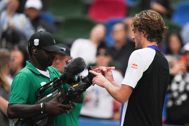 (241008) -- SHANGHAI, Oct. 8, 2024 -- Stefanos Tsitsipas (R) signs an autograph on the camera after the men s singles round of 32 match between Stefanos Tsitsipas of Greece and Alexandre Muller of France at the ATP, Tennis Herren World Tour Shanghai Masters tennis tournament in Shanghai, east China, Oct. 8, 2024. ) (SP)CHINA-SHANGHAI-TENNIS-ATP TOUR-SHANGHAI MASTERS(CN) XuxYanan 