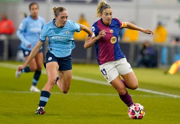Manchester, England, 9th October 2024. Alexia Putellas of Barcelona (R) is challenged by Naomi Layzell of Manchester City during the UEFA Womens Champions League match at the Academy Stadium, Manchester. Picture credit should read: Andrew Yates Sportimage EDITORIAL USE ONLY. No use with unauthorised audio, video, data, fixture lists, club league logos or live services. Online in-match use limited to 120 images, no video emulation. No use in betting, games or single club league player publications. SPI-3368-0005