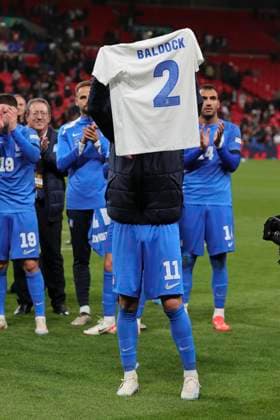 England v Greece UEFA Nations League Anastasios Bakasetas of Greece holds up a shirt with George Baldock™s name on it at the end of the UEFA Nations League Group F match at Wembley Stadium, London UK Newspapers OUT Copyright: xPaulxChestertonx FIL-20749-0109