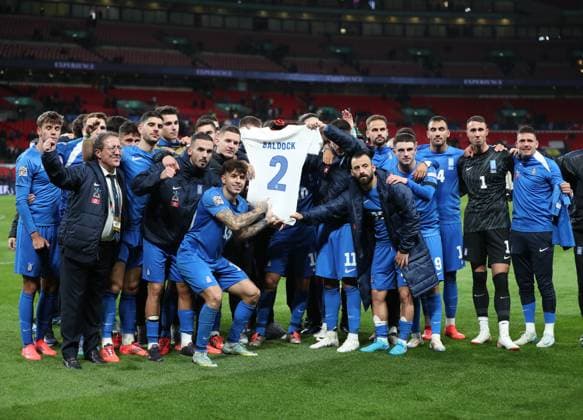 London, England, 10th October 2024. The Greece tame hold up a shirt in respect of George Baldock who recently passed away this week during the UEFA Nations League match at Wembley Stadium, London. Picture credit should read: Paul Terry Sportimage EDITORIAL USE ONLY. No use with unauthorised audio, video, data, fixture lists, club league logos or live services. Online in-match use limited to 120 images, no video emulation. No use in betting, games or single club league player publications. SPI-3369-0049