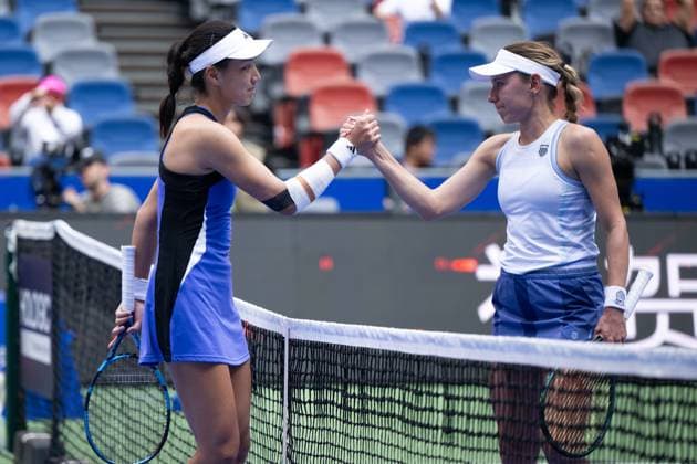 (241011) -- WUHAN, Oct. 11, 2024 -- Wang Xinyu (L) greets Ekaterina Alexandrova after the women s singles quarterfinal between Wang Xinyu of China and Ekaterina Alexandrova of Russia at the 2024 Wuhan Open tennis tournament in Wuhan, capital of central China s Hubei Province, Oct. 11, 2024. ) (SP)CHINA-WUHAN-TENNIS-WUHAN OPEN-WOMEN S SINGLES (CN) XiaoxYijiu 