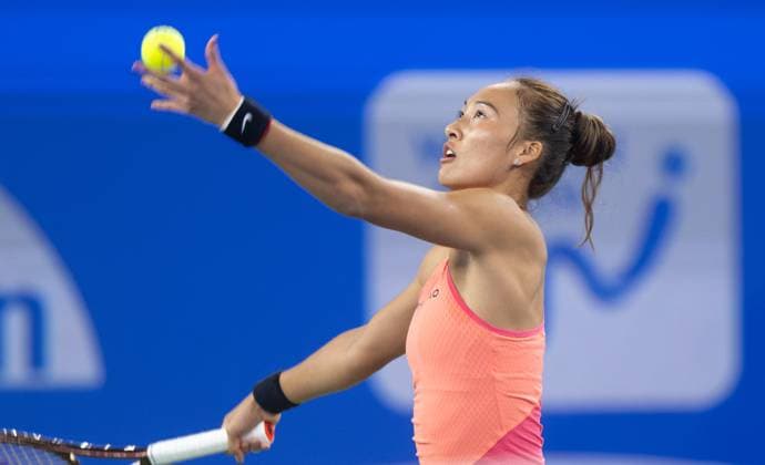 (241011) -- WUHAN, Oct. 11, 2024 -- Zheng Qinwen serves during the women s singles quarterfinal match between Zheng Qinwen of China and Jasmine Paolini of Italy at the 2024 Wuhan Open tennis tournament in Wuhan, capital of central China s Hubei Province, Oct. 11, 2024. ) (SP)CHINA-WUHAN-TENNIS-WUHAN OPEN-WOMEN S SINGLES (CN) XiaoxYijiu 