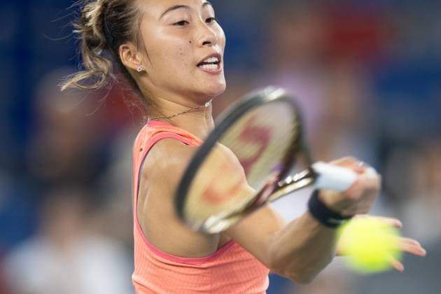 (241011) -- WUHAN, Oct. 11, 2024 -- Zheng Qinwen hits a return during the women s singles quarterfinal match between Zheng Qinwen of China and Jasmine Paolini of Italy at the 2024 Wuhan Open tennis tournament in Wuhan, capital of central China s Hubei Province, Oct. 11, 2024. ) (SP)CHINA-WUHAN-TENNIS-WUHAN OPEN-WOMEN S SINGLES (CN) XiaoxYijiu 