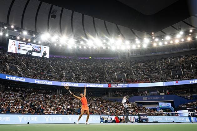 (241012) -- WUHAN, Oct. 12, 2024 -- Zheng Qinwen serves during the women s singles semifinal match between Zheng Qinwen of China and Wang Xinyu of China at the 2024 Wuhan Open tennis tournament in Wuhan, central China s Hubei Province, Oct. 12, 2024. ) (SP)CHINA-WUHAN-TENNIS-WUHAN OPEN-WOMEN S SINGLES (CN) XiaoxYijiu 