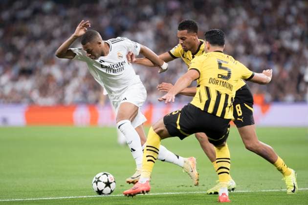 UEFA champions league - Real Madrid vs Borussia Dortmund MADRID, SPAIN - October 22: Kylian Mbappe of Real Madrid and Ramy Bensebaini of Borussia Dortmund fight for the ball during the UEFA champions league 2024 25 match between Real Madrid and Borussia Dortmund at Santiago Bernabeu Stadium. (Photo by Guillermo Martinez) Madrid Santiago BernabÃ u Stadium Spain Copyright: xGuillermoxMartinezx
