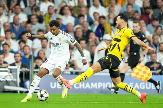 Real Madrid C.F. v Borussia- UEFA Champions League 2024 25 League Phase MD3 Rodrygo Goes right winger of Real Madrid and Brazil and Ramy Bensebaini left-back of Borussia and Algeria compete for the ball during the UEFA Champions League 2024 25 League Phase MD3 match between Real Madrid C.F. and Borussiaat Estadio Santiago Bernabeu on October 22, 2024 in Madrid, Spain. Madrid Spain  Copyright: xJosexBretonx originalFilename:bretonhernandez-realmadr241022_nptu0.jpg