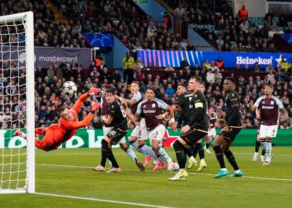 Birmingham, England, 22nd October 2024. Bologna s goalkeeper Lukasz Skorupski dives in vain as Villa score their first goal through a free kick by John McGinn during the UEFA Champions League match at Villa Park, Birmingham. Picture credit should read: Andrew Yates Sportimage EDITORIAL USE ONLY. No use with unauthorised audio, video, data, fixture lists, club league logos or live services. Online in-match use limited to 120 images, no video emulation. No use in betting, games or single club league player publications. SPI-3403-0035