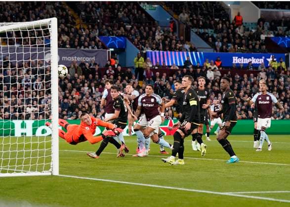Birmingham, England, 22nd October 2024. Bologna s goalkeeper Lukasz Skorupski dives in vain as Villa score their first goal through a free kick by John McGinn during the UEFA Champions League match at Villa Park, Birmingham. Picture credit should read: Andrew Yates Sportimage EDITORIAL USE ONLY. No use with unauthorised audio, video, data, fixture lists, club league logos or live services. Online in-match use limited to 120 images, no video emulation. No use in betting, games or single club league player publications. SPI-3403-0036