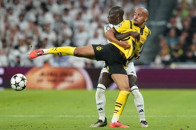 Real Madrid CF s Ferland Mendy (l) and Borussia Dortmund s Donyell Malen during Champions League 2024 2025 match. October 22,2024. (20241022320)
