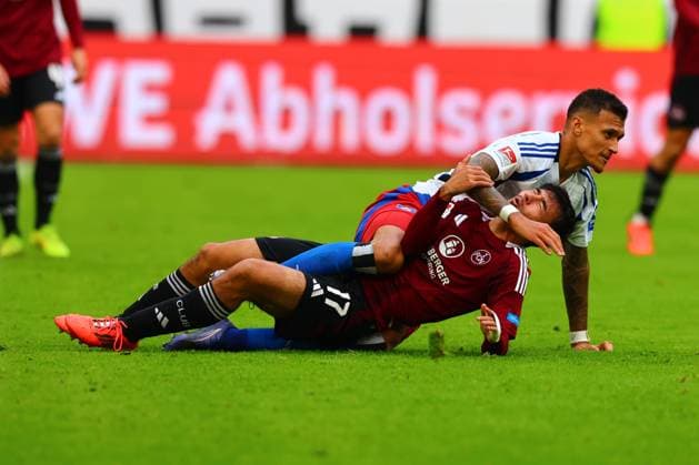 GER, Hamburg, Football, DFB, HSV vs 1 FC Nuernberg, im Volkspark Stadion, 03 11 2024, f l Jens Castrop 1 FC Nuernberg , Davie Selke Hamburger SV lie on the ground after the foul DFL regulations prohibit any use of photographs as image sequences and or quasi video Copyright: HMBxMedia FernandoxSoares