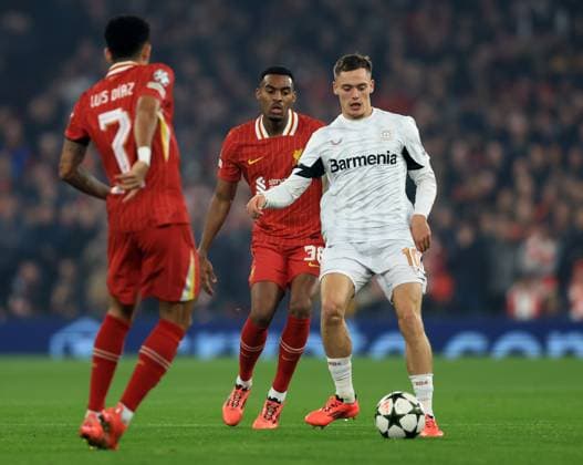 Liverpool, England, 5th November 2024. Ryan Gravenberch of Liverpool with Florian Wirtz of Bayer Leverkusen during the UEFA Champions League match at Anfield, Liverpool. Picture credit should read: Jessica Hornby Sportimage EDITORIAL USE ONLY. No use with unauthorised audio, video, data, fixture lists, club league logos or live services. Online in-match use limited to 120 images, no video emulation. No use in betting, games or single club league player publications. SPI-3439-0027