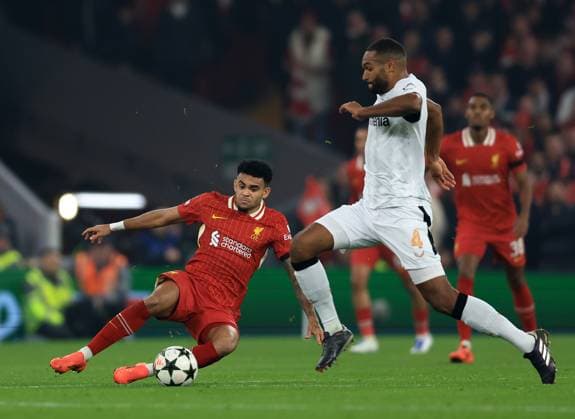 Liverpool, England, 5th November 2024. Luis Diaz of Liverpool with Jonathan Tah of Bayer Leverkusen during the UEFA Champions League match at Anfield, Liverpool. Picture credit should read: Jessica Hornby Sportimage EDITORIAL USE ONLY. No use with unauthorised audio, video, data, fixture lists, club league logos or live services. Online in-match use limited to 120 images, no video emulation. No use in betting, games or single club league player publications. SPI-3439-0046
