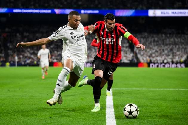 Real Madrid CF v AC Milan - UEFA Champions League Theo Hernandez of AC Milan competes for the ball with Vinicius Junior of Real Madrid CF during the UEFA Champions League 2024 25 league phase football match between Real Madrid CF and AC Milan. Madrid Spain Copyright: xNicolòxCampox