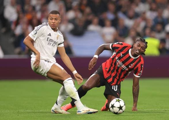 Madrid, Spain, 5th November 2024. Rafael Leao of AC Milan and Kylian Mbappe of Real Madrid during the UEFA Champions League match at the Santiago Bernabau, Madrid. Picture credit should read: Jonathan Moscrop Sportimage EDITORIAL USE ONLY. No use with unauthorised audio, video, data, fixture lists, club league logos or live services. Online in-match use limited to 120 images, no video emulation. No use in betting, games or single club league player publications. SPI-3425-0044