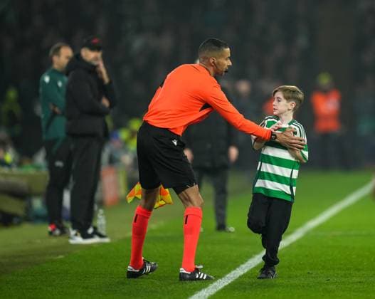 A young Celtic fan who ran on to the pitch during the match is stopped by Assistant Referee Hicham Zakrani. Celtic v RB Leipzig, UEFA Champions League, Group Stage, Football, Celtic Park, Glasgow, Scotland, UK - 05 Nov 2024 EDITORIAL USE ONLY No use with unauthorised audio, video, data, fixture lists, club league logos or live services. Online in-match use limited to 120 images, no video emulation. No use in betting, games or single club league player publications. Copyright: xStuartxWallace Shutterstockx 14863772co