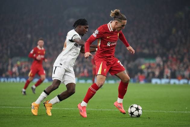 Liverpool, England, 5th November 2024. Kostas Tsimikas of Liverpool controls the ball whilst under pressure from Jeremy Frimpong of Bayer Leverkusen during the UEFA Champions League match at Anfield, Liverpool. Picture credit should read: Jessica Hornby Sportimage EDITORIAL USE ONLY. No use with unauthorised audio, video, data, fixture lists, club league logos or live services. Online in-match use limited to 120 images, no video emulation. No use in betting, games or single club league player publications. SPI-3439-0099