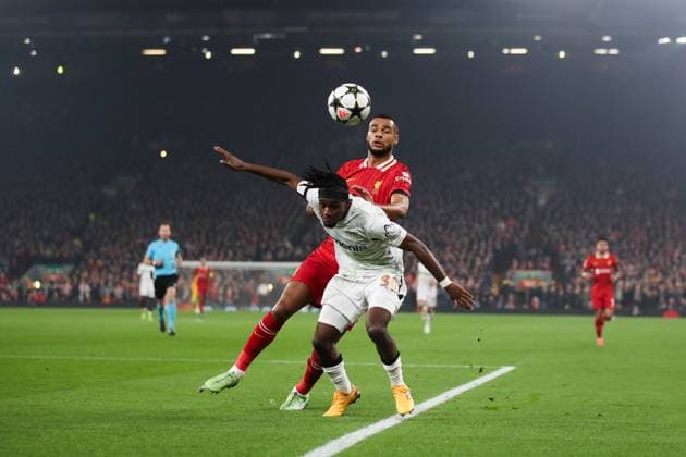 Liverpool, England, 5th November 2024. Jeremy Frimpong of Bayer Leverkusen battles for possession with Cody Gakpo of Liverpool during the UEFA Champions League match at Anfield, Liverpool. Picture credit should read: Jessica Hornby Sportimage EDITORIAL USE ONLY. No use with unauthorised audio, video, data, fixture lists, club league logos or live services. Online in-match use limited to 120 images, no video emulation. No use in betting, games or single club league player publications. SPI-3439-0101