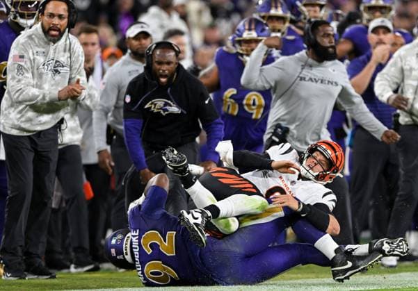 Sport Themen der Woche KW45 Cincinnati Bengals quarterback Joe Burrow (9) is tackled on the sideline by Baltimore Ravens defensive tackle Nnamdi Madubuike (92) during the first half at M&T Bank Stadium in Baltimore, Maryland, on Thursday, November 7, 2024.  BAL20241107114 DAVIDxTULIS