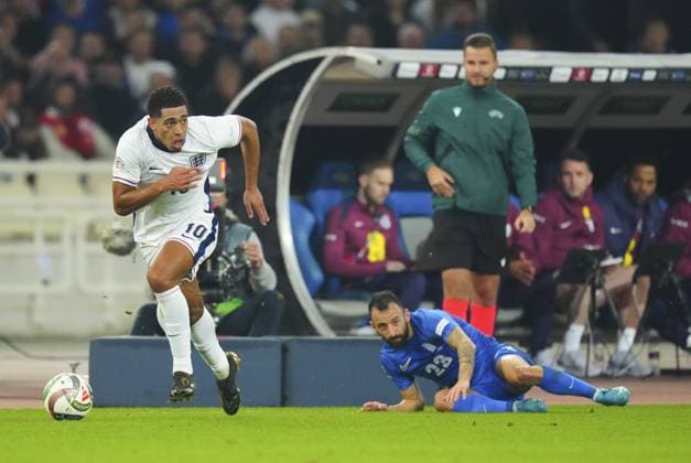 Jude Bellingham of England slips away from Manolis Siopis of Greece Greece v England, UEFA Nations League, League B, Group 2, Football, Olympic Stadium, Athens, Greece - 14 Nov 2024 EDITORIAL USE ONLY No use with unauthorised audio, video, data, fixture lists, club league logos or live services. Online in-match use limited to 120 images, no video emulation. No use in betting, games or single club league player publications. Copyright: xJavierxGarcia Shutterstockx 14902321al