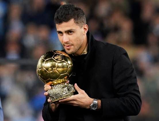 Manchester, England, 23rd November 2024. Rodri of Manchester City receives his Ballon d Or trophy during the Premier League match at the Etihad Stadium, Manchester. Picture credit should read: Andrew Yates Sportimage EDITORIAL USE ONLY. No use with unauthorised audio, video, data, fixture lists, club league logos or live services. Online in-match use limited to 120 images, no video emulation. No use in betting, games or single club league player publications. SPI-3466-0122