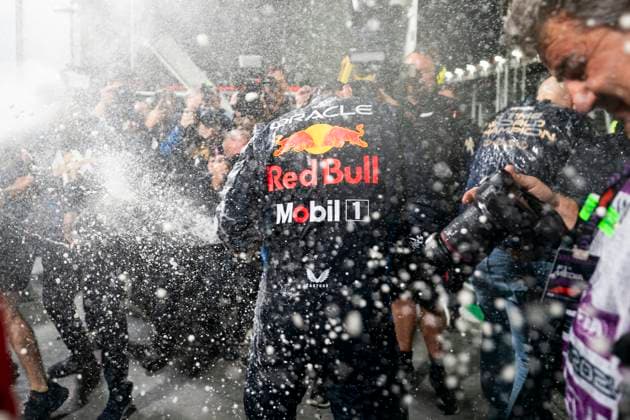 Red Bull Racing team members spray champagne following a celebratory photo for Dutch Formula One driver Max Verstappen for clinching his fourth drivers World Championship, WM, Weltmeisterschaft following the Formula One Las Vegas Grand Prix at the Las Vegas Strip Circuit in Las Vegas on Sunday, November 24, 2024.  LAV2024112412 GREGxNASH