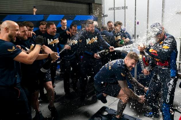 Red Bull Racing team members spray champagne following a celebratory photo for Dutch Formula One driver Max Verstappen for clinching his fourth drivers World Championship, WM, Weltmeisterschaft following the Formula One Las Vegas Grand Prix at the Las Vegas Strip Circuit in Las Vegas on Sunday, November 24, 2024.  LAV2024112411 GREGxNASH