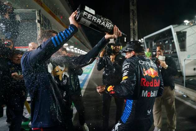 Red Bull Racing team members spray champagne following a celebratory photo for Dutch Formula One driver Max Verstappen for clinching his fourth drivers World Championship, WM, Weltmeisterschaft following the Formula One Las Vegas Grand Prix at the Las Vegas Strip Circuit in Las Vegas on Sunday, November 24, 2024.  LAV2024112414 GREGxNASH