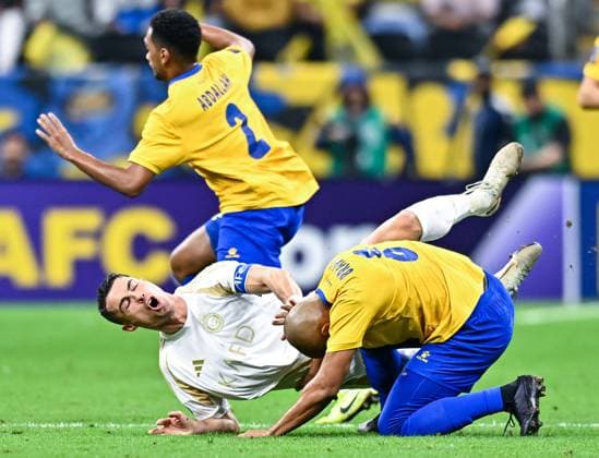 AFC CHAMPIONS LEAGUE ELITE, AL GHARAFA SC (QTR) v AL NASSR FC (KSA) Cristiano Ronaldo (L) of Al Nassr FC and Yacine Brahimi of Al Gharafa SCin action during the AFC Champions League elite west football match between Qatar s Al Gharafa SC and Saudi Arabia s Al Nassr FC at Al-Bayt Stadium in Al Khor, Qatar, on November 25, 2024 DOHA Qatar Copyright: xNAUSHADx