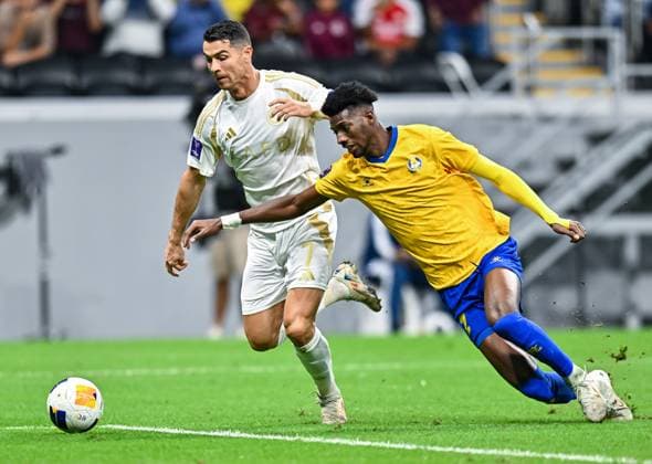 AFC CHAMPIONS LEAGUE ELITE, AL GHARAFA SC (QTR) v AL NASSR FC (KSA) Cristiano Ronaldo (L) of Al Nassr FC and Seydou Sano of Al Gharafa SC in action during the AFC Champions League elite west football match between Qatar s Al Gharafa SC and Saudi Arabia s Al Nassr FC at Al-Bayt Stadium in Al Khor, Qatar, on November 25, 2024 DOHA Qatar Copyright: xNAUSHADx