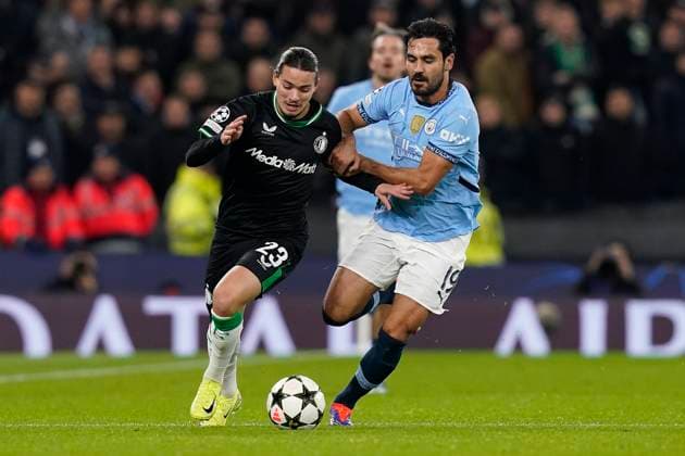 Manchester, England, 26th November 2024. Anis Hadj Moussa of Feyenoord and Ä°lkay Gundogan of Manchester City challenge for the ball during the UEFA Champions League match at the Etihad Stadium, Manchester. Picture credit should read: Andrew Yates Sportimage EDITORIAL USE ONLY. No use with unauthorised audio, video, data, fixture lists, club league logos or live services. Online in-match use limited to 120 images, no video emulation. No use in betting, games or single club league player publications. SPI-3484-0019