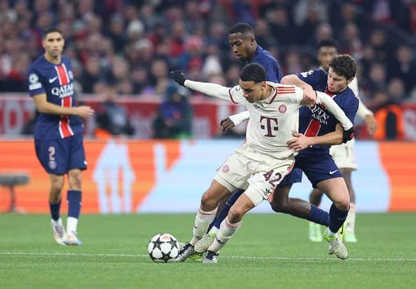 Jamal Musiala of Bayern Munich competes for the ball with Joao Neves of Paris Saint-Germain Bayern Munich v Paris Saint-Germain, UEFA Champions League, Group Stage, Football, Allianz Arena, Munich, Germany - 26 Nov 2024 EDITORIAL USE ONLY No use with unauthorised audio, video, data, fixture lists, club league logos or live services. Online in-match use limited to 120 images, no video emulation. No use in betting, games or single club league player publications. Copyright: xMichaelxZemanek Shutterstockx 14940166cc