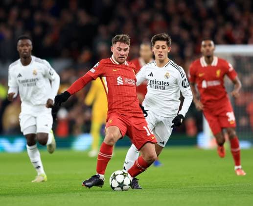 Liverpool, England, 27th November 2024. Liverpool™s Alexis Mac Allister with Real Madrid™s Arda Guler during the UEFA Champions League match at Anfield, Liverpool. Picture credit should read: Jessica Hornby Sportimage EDITORIAL USE ONLY. No use with unauthorised audio, video, data, fixture lists, club league logos or live services. Online in-match use limited to 120 images, no video emulation. No use in betting, games or single club league player publications. SPI-3486-0038