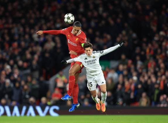Liverpool, England, 27th November 2024. Liverpool™s Virgil van Dijk with Real Madrid™s Arda Guler during the UEFA Champions League match at Anfield, Liverpool. Picture credit should read: Jessica Hornby Sportimage EDITORIAL USE ONLY. No use with unauthorised audio, video, data, fixture lists, club league logos or live services. Online in-match use limited to 120 images, no video emulation. No use in betting, games or single club league player publications. SPI-3486-0048