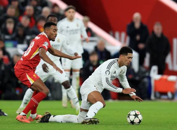 27th November 2024; Anfield, Liverpool, Merseyside, England; Champions League Football, Liverpool versus Real Madrid; Jude Bellingham of Real Madrid is tripped by Ryan Gravenberch of Liverpool  ActionPlus12720700 DavidxBlunsden