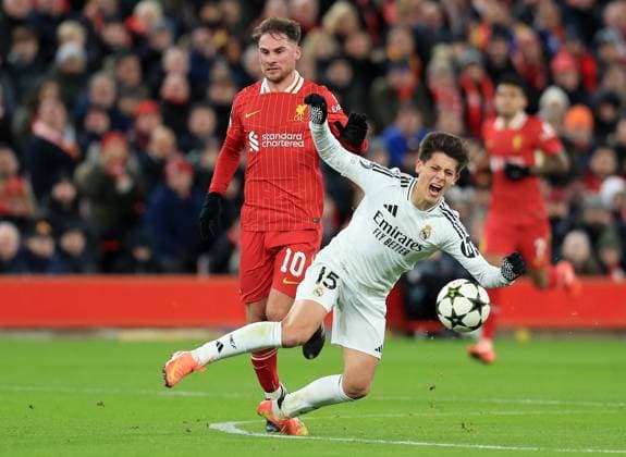 27th November 2024; Anfield, Liverpool, Merseyside, England; Champions League Football, Liverpool versus Real Madrid; Arda Guler of Real Madrid is tripped by Alexis MacAllister of Liverpool  ActionPlus12720710 DavidxBlunsden
