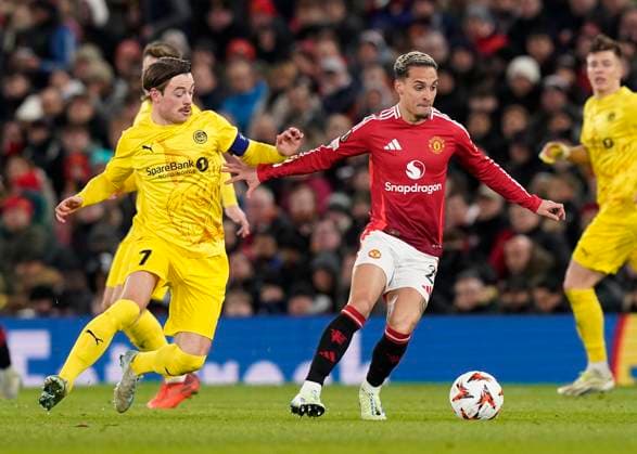 Manchester, England, 28th November 2024. Patrick Berg of FK Bodo Glimt tackles Antony of Manchester United, ManU during the UEFA Europa League match at Old Trafford, Manchester. Picture credit should read: Andrew Yates Sportimage EDITORIAL USE ONLY. No use with unauthorised audio, video, data, fixture lists, club league logos or live services. Online in-match use limited to 120 images, no video emulation. No use in betting, games or single club league player publications. SPI-3487-0074
