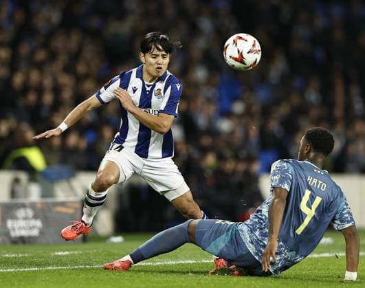 Football: UEFA Europa League Real Sociedad s Takefusa Kubo (L) plays in the second half of a UEFA Europa League football match against Ajax in San Sebastian, Spain, on Nov. 28, 2024.  A14AA0003794324P