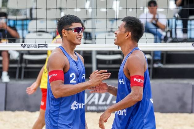 (241129) -- LAGUNA PROVINCE, Nov. 29, 2024 -- Lerry John Francisco (L) and James Buytrago of the Philippines celebrate after scoring a point during the men s pool A match between England and the Philippines at the 2024 Volleyball World Beach Pro Tour Challenge in Laguna Province, the Philippines, Nov. 29, 2024. ) (SP)PHILIPPINES-LAGUNA PROVINCE-VOLLEYBALL WORLD BEACH PRO TOUR CHALLENGE RouellexUmali 
