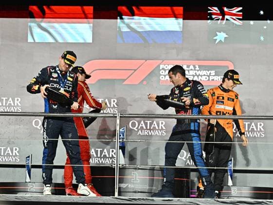 FORMULA ONE QATAR GRAND PRIX 2024 (L-R) The winner Red Bull Racing driver Max Verstappen of Netherlands,Second-placed Scuderia Ferrari driver Charles Leclerc of Monaco, Red Bull Racing mechanic Chris Gent and third-placed McLaren driver Oscar Piastri of Australia celebrate on the podium after the Formula 1 Grand Prix of Qatar at Lusail International Circuit in Lusail, Qatar,, on December 1, 2024. DOHA Qatar Copyright: xNOUSHADx
