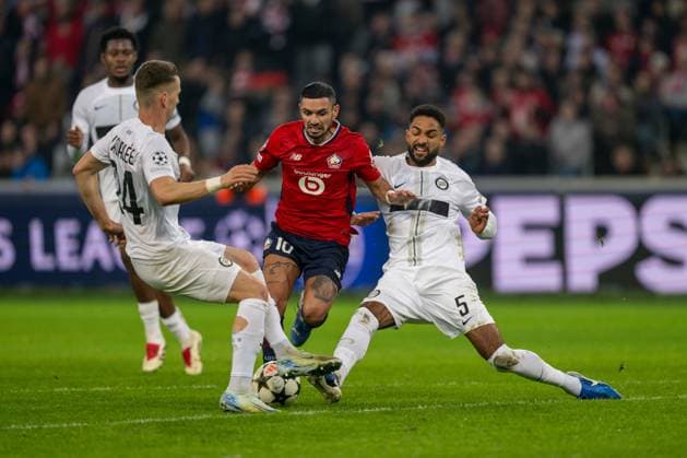 SOCCER - UEFA CL, Lille vs Sturm LILLE,FRANCE,11.DEC.24 - SOCCER - UEFA Champions League, OSC Lille vs SK Sturm Graz. Image shows Dimitri Lavalee (Sturm), Remy Cabella (Lille) and Gregory Wuethrich (Sturm).  GEPAxpictures xAvnixRetkoceri