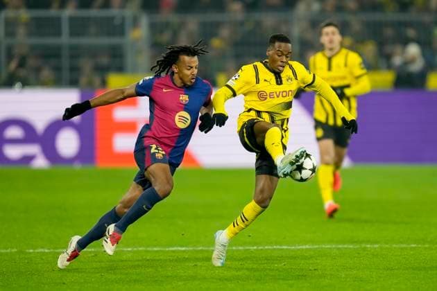 Jules Kounde FC Barcelona and Jamie Gittens Borussia Dortmund battle for the ball during the UEFA Champions League 2024 25 League Phase MD6 match between Borussia Dortmund and FC Barcelona at Signal Iduna Park on December 11, 2024 in Dortmund, Germany Photo by Alex Gottschalk DeFodi Images Defodi 001 BVBFCB20241211 151 Defodi-001