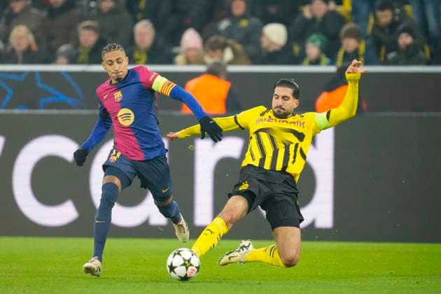 Raphinha FC Barcelona and Emre Can Borussia Dortmund battle for the ball during the UEFA Champions League 2024 25 League Phase MD6 match between Borussia Dortmund and FC Barcelona at Signal Iduna Park on December 11, 2024 in Dortmund, Germany Photo by Alex Gottschalk DeFodi Images Defodi 001 BVBFCB20241211 156 Defodi-001