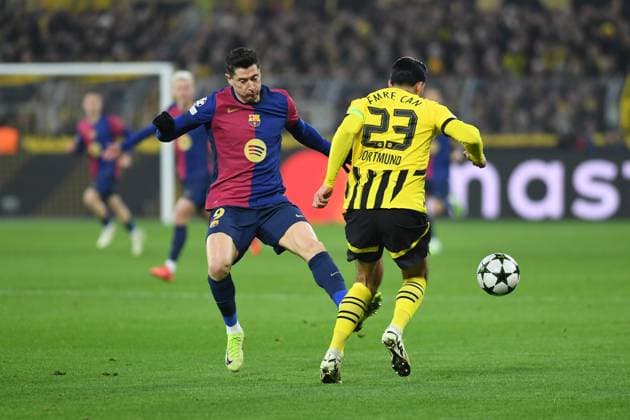 persons in a duel during the UEFA Champions League 2024 25 League Phase 6 match between Borussia Dortmund and FC Barcelona, SIGNAL IDUNA PARK on December 11, 2024 in Dortmund, Germany, Germany Photo by Ralf Treese DeFodi Images Robert Lewandowski FC Barcelona and Emre Can Borussia Dortmund battle for the ball during the UEFA Champions League 2024 25 League Phase MD6 match between Borussia Dortmund and FC Barcelona at Signal Iduna Park on December 11, 2024 in Dortmund, Germany Defodi 521 BVBFCB20241211 023 Defodi-521